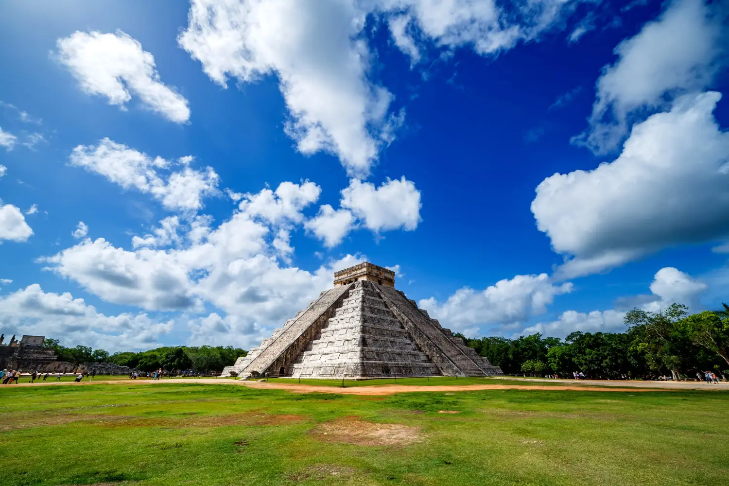 El Castillo pyramid at Chichén Itzá beneath dramatic blue sky