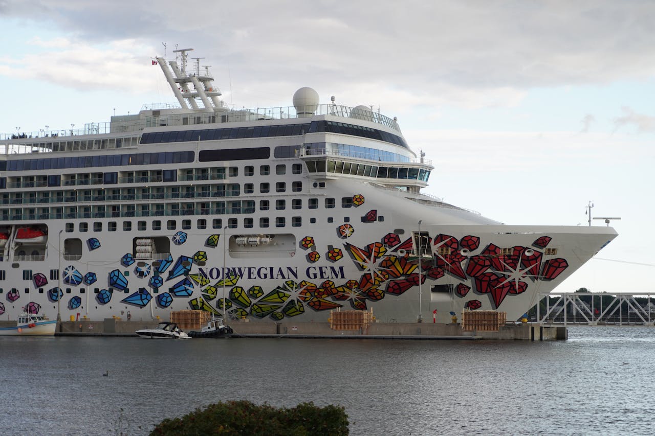 Norwegian Gem cruise ship docked at port with colorful hull artwork