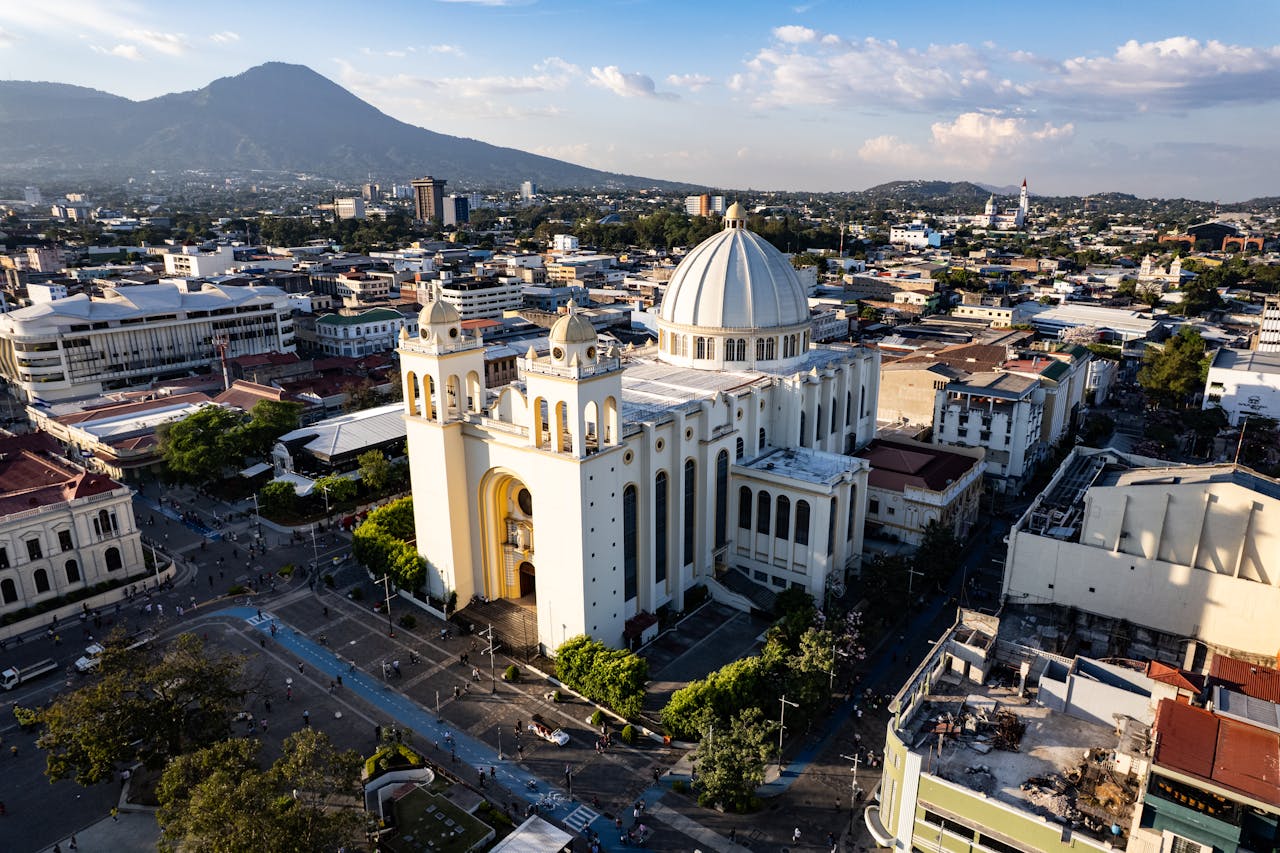 Aerial view of cathedral and surrounding cityscape with mountains in the background