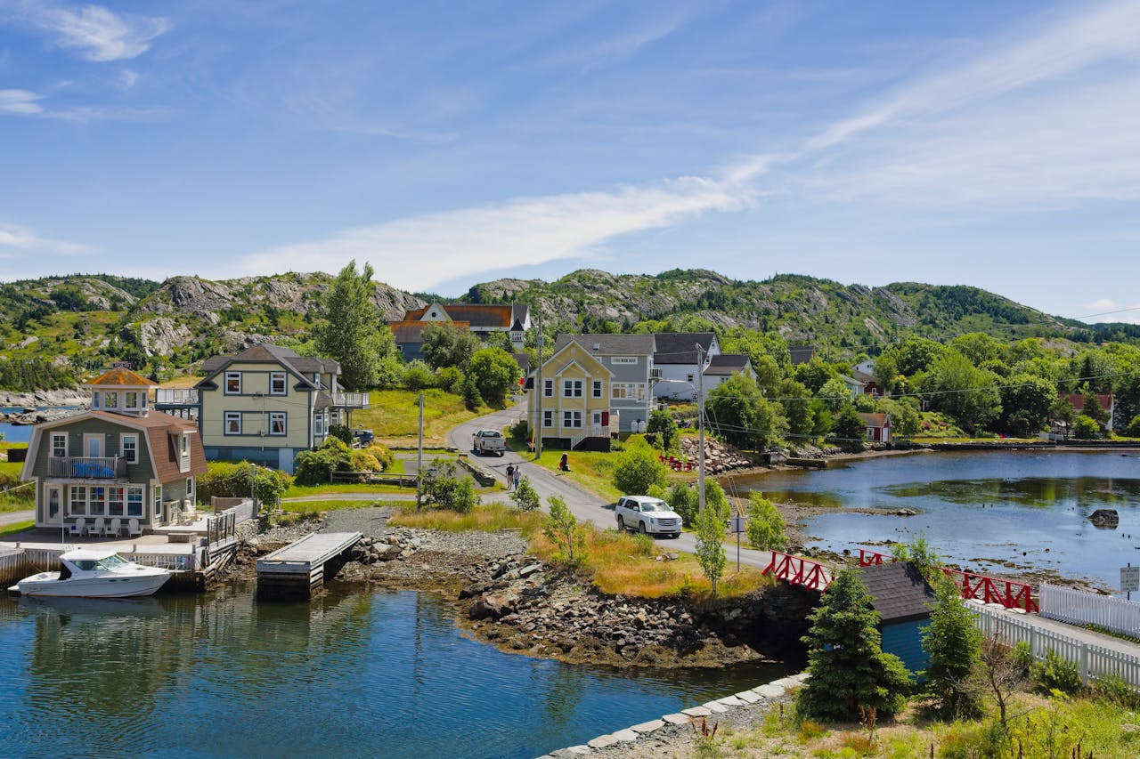Scenic Canadian coastal village with waterfront homes and rocky green landscape