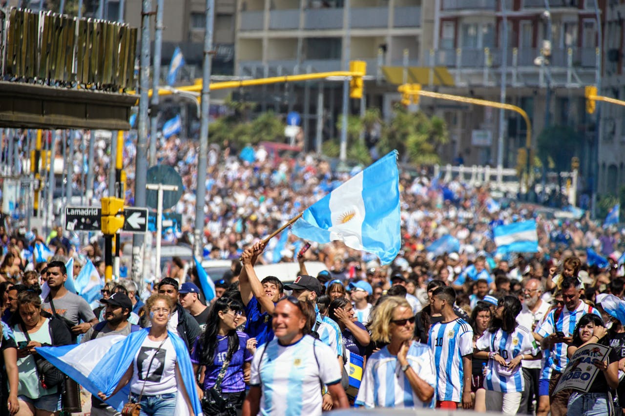 Crowd celebrating with Argentine flags during a public gathering in Argentina