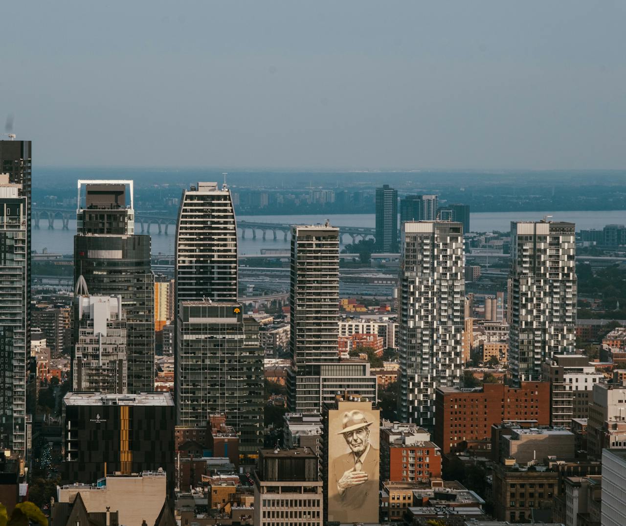 Modern urban skyline with high-rise buildings and bridge in the distance