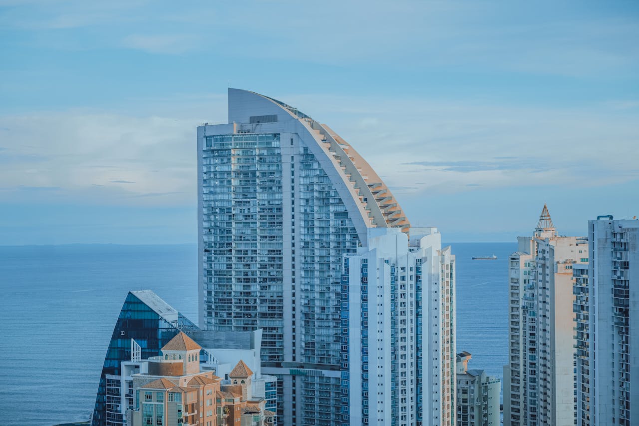 Modern coastal city skyline with high-rise residential buildings overlooking the ocean