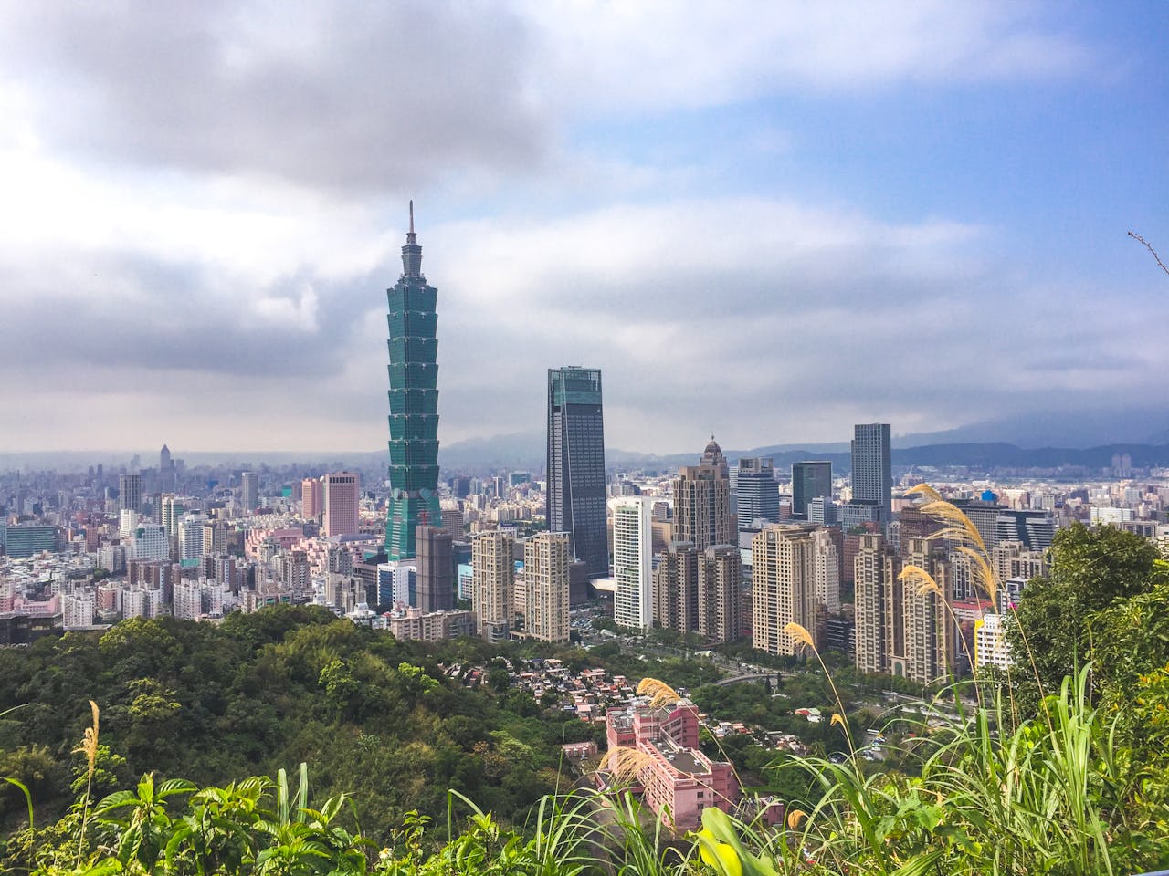 Taipei skyline featuring Taipei 101 beneath dramatic cloudy sky