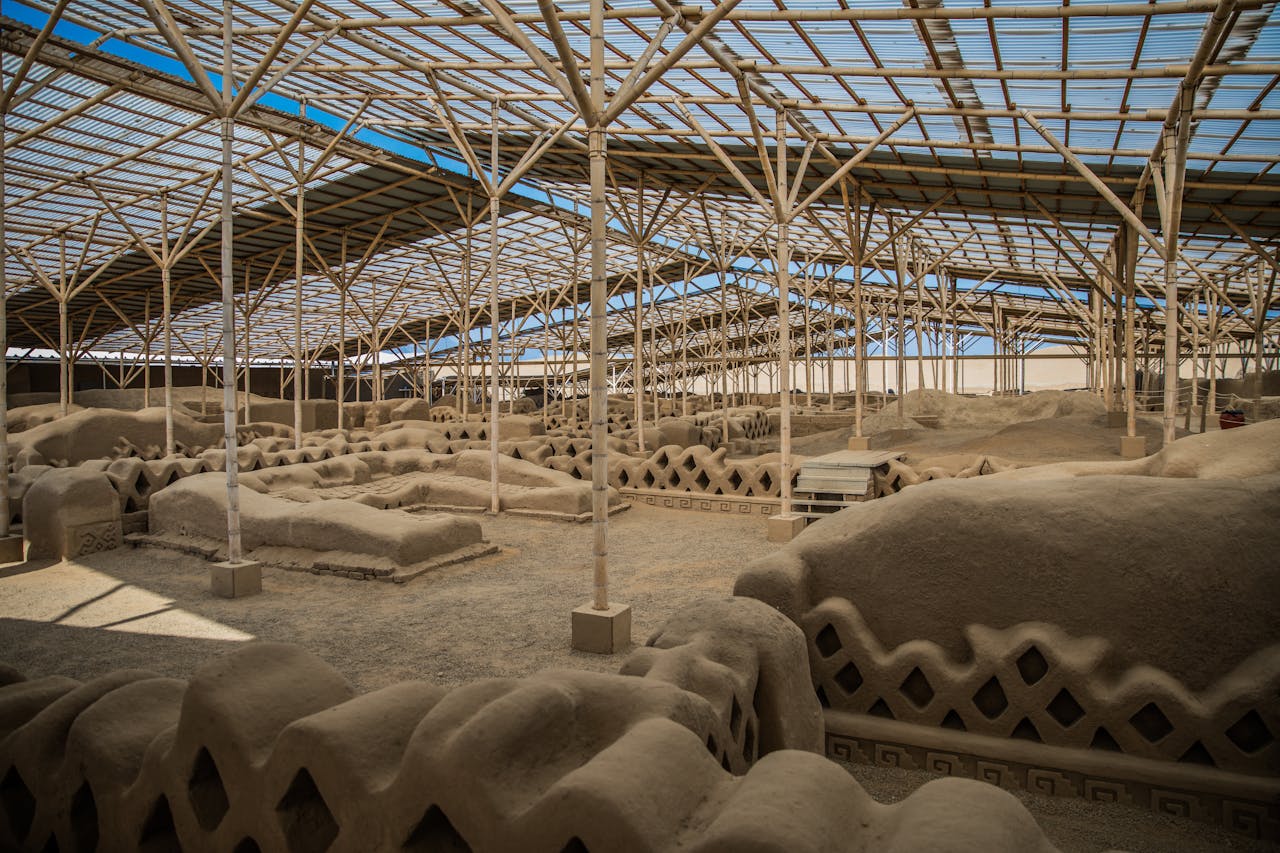 Ancient adobe archaeological ruins preserved beneath a protective roof in Peru