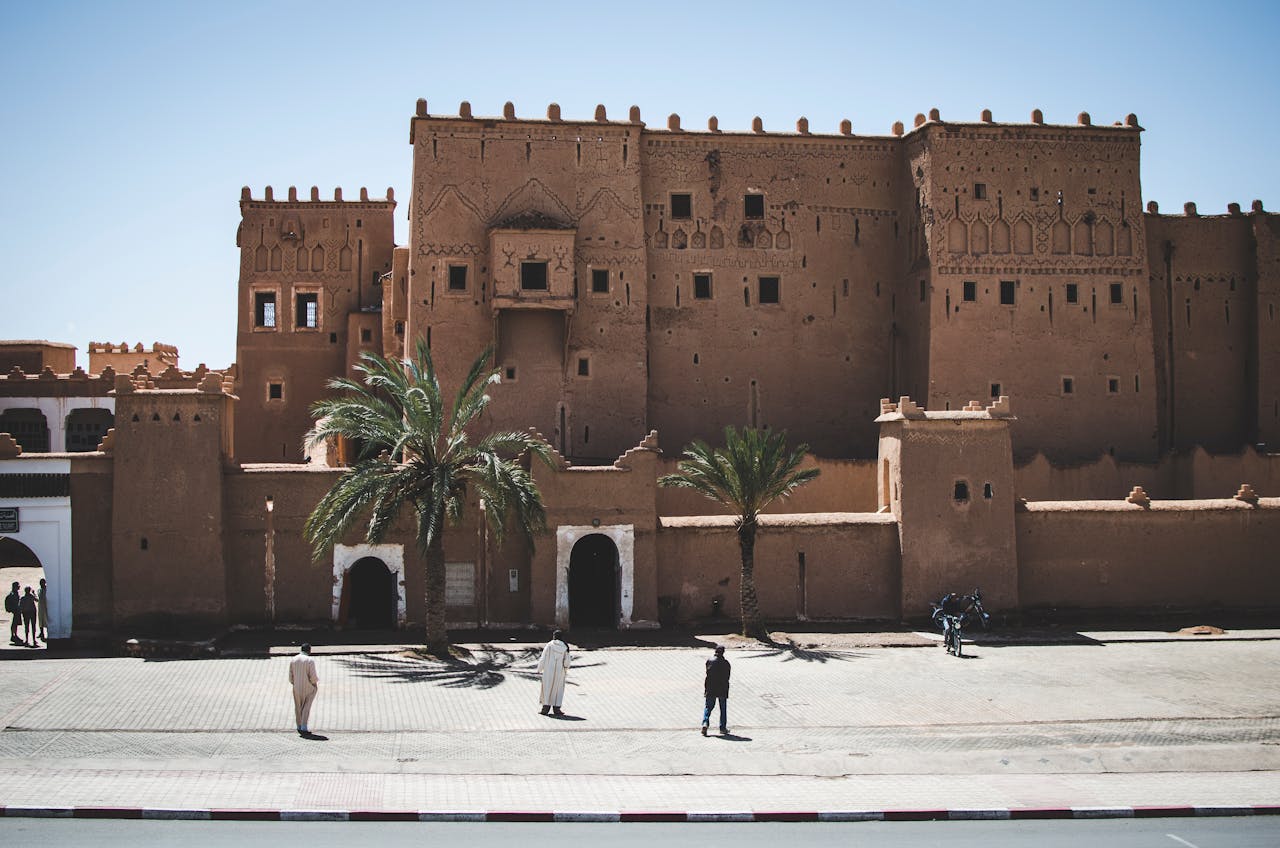 Historic earthen kasbah with palm trees in Ouarzazate, Morocco