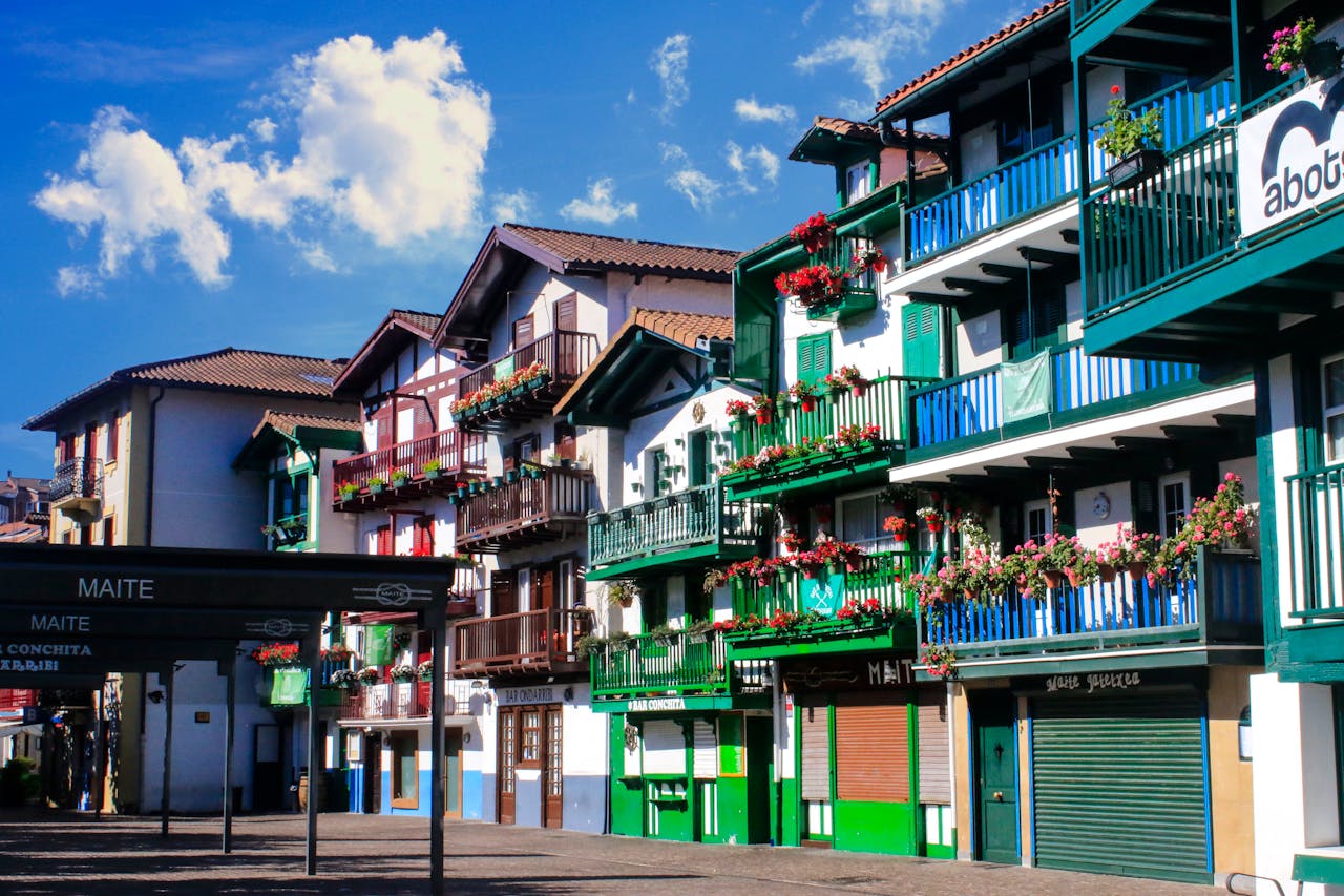 Colorful traditional houses with flower-filled balconies in European town