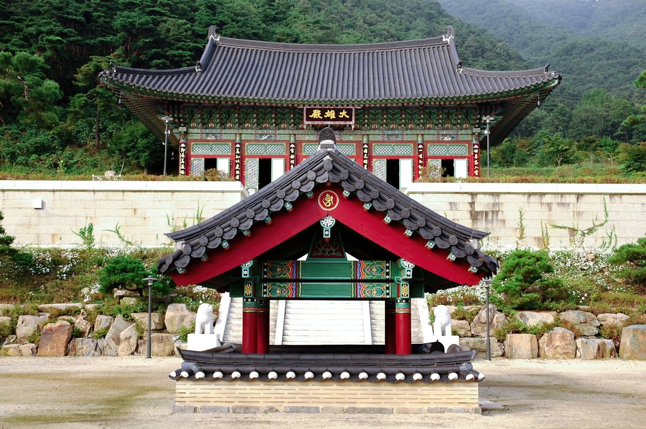 Traditional Korean Buddhist temple with colorful architecture and mountain backdrop