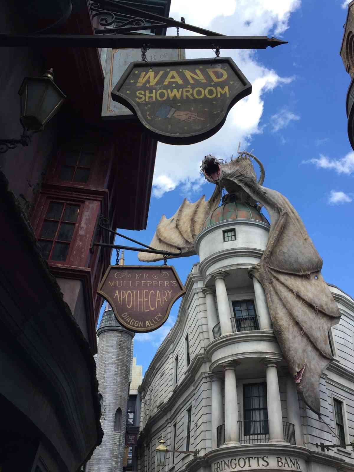 Dragon overlooking Diagon Alley and Gringotts Bank beneath a bright blue sky