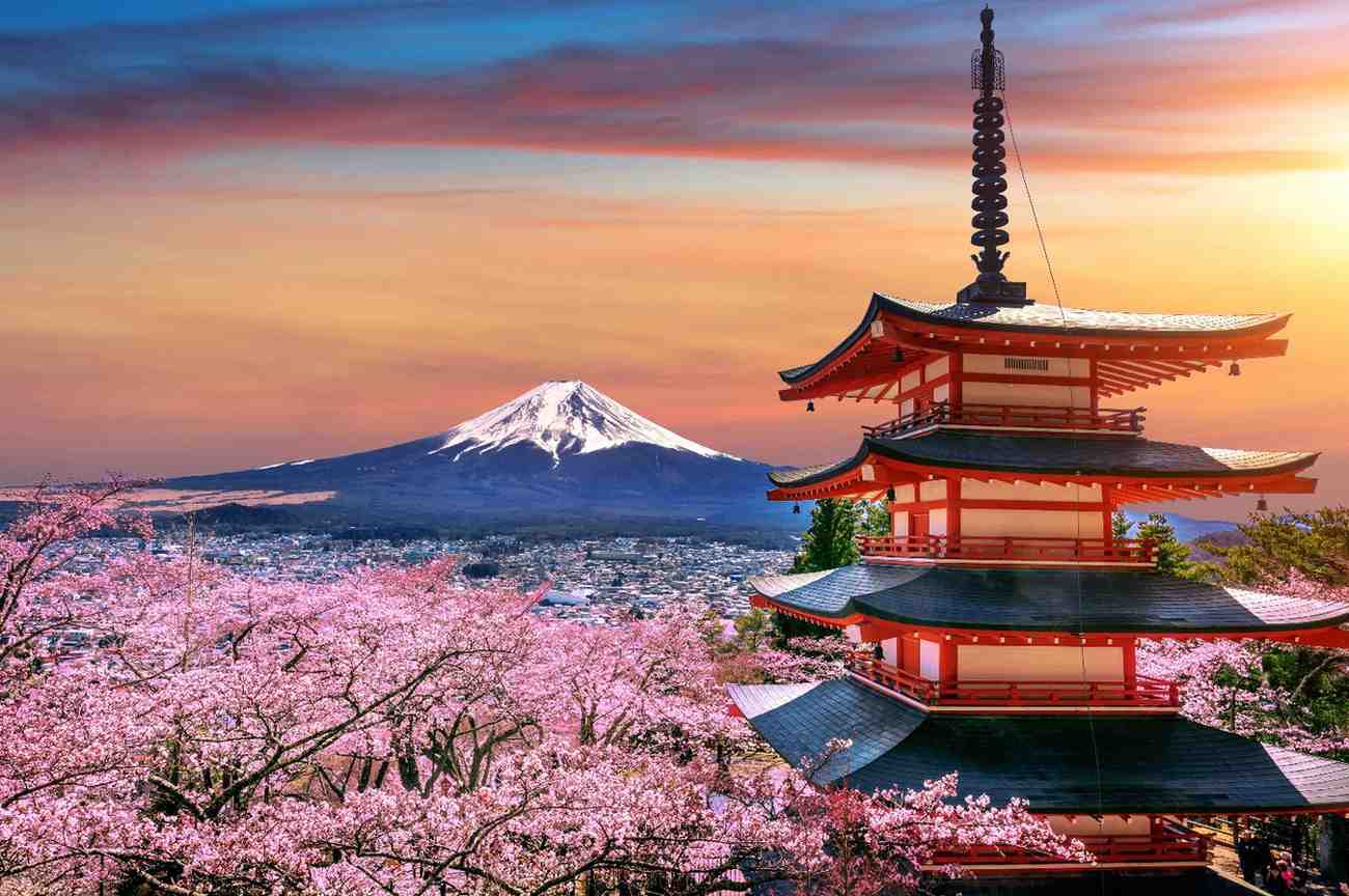 Mount Fuji and traditional Japanese pagoda surrounded by cherry blossoms